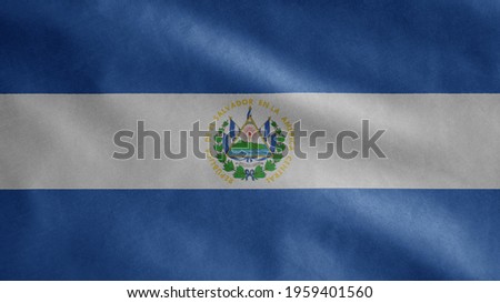 Salvadorean flag waving in the wind. Close up of Salvador banner blowing, soft and smooth silk. Cloth fabric texture ensign background. Use it for national day and country occasions concept.