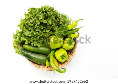 Fresh Green Vegetables in basket on white isolated background top view.