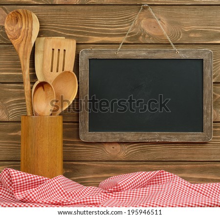 Writing board and spoons on brown background