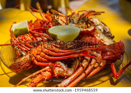 lobsters with lemon on a plate in restaurant on the beach