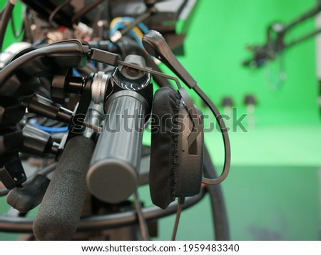 camera headphone broadcast television studio camera with greenscreen at TV station.