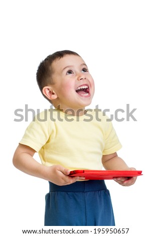 happy kid boy playing with pc tablet and looking up