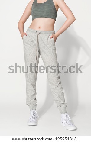 Sporty woman in sports bra and sweatpants for activewear photoshoot Royalty-Free Stock Photo #1959513181