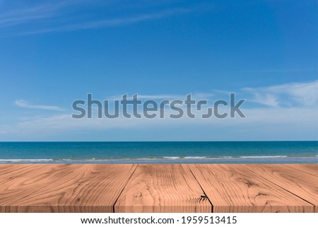 Top of the empty wood table with the blur of the sea background