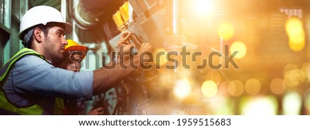 Industrial workers are working in the factory. Machine engineers or mechanical technicians and assistants are helping to repair and inspect the machine's readiness before the product is manufactured. Royalty-Free Stock Photo #1959515683
