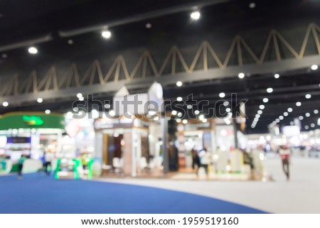 Abtract blur people in exhibition hall event tradeshow background. Business event exhibition, meeting convention center and expo organizer concept.