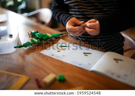 Kid building aircraft with brick toy education photo Royalty-Free Stock Photo #1959524548