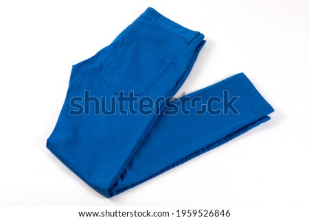 Blue jeans isolated on white background. Folded casual style trousers or pants.  Royalty-Free Stock Photo #1959526846