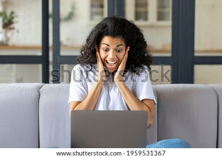Excited happy African American woman sitting on couch at home feel euphoric win online lottery or get mail at laptop with great news, Recruitment