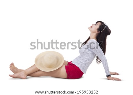 Beautiful woman wearing sun hat and sitting on white background