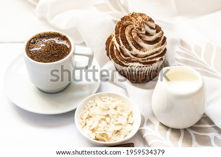 Dark chocolate and cocoa chocolate cupcakes with cup of hot black coffee