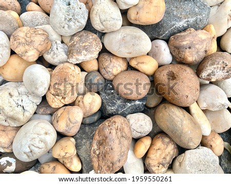 Background photo,close-up shot of multi-colored pebble stone, 30-50mm in size texture detail, grunge style is a copy space