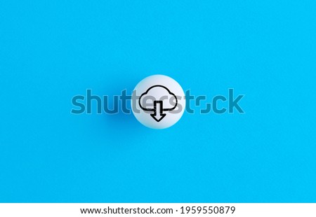 Download symbol on a ball button on blue background. Royalty-Free Stock Photo #1959550879