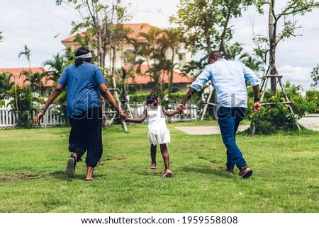 Portrait of enjoy happy love black family african american father and mother holding little african girl hand in moments good time in summer park at home