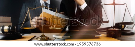 Women lawyer working with contract papers and wooden gavel on tabel in courtroom. justice and law ,attorney, court judge, concept