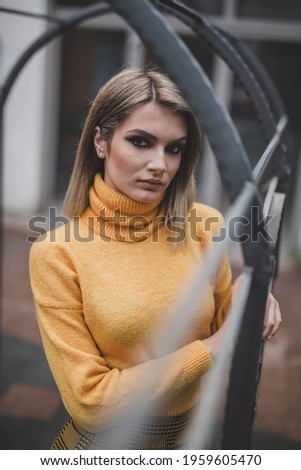 A shallow focus shot of a young attractive Caucasian female with trendy makeup posing at camera