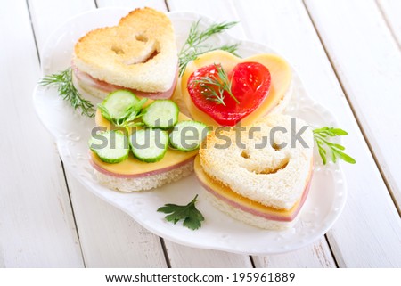 Heart shaped toasts with ham and cheese Royalty-Free Stock Photo #195961889