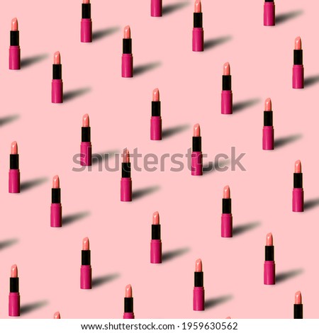 Red lipstick on pink colored background in pop art style. Minimal makeup cosmetic pattern Royalty-Free Stock Photo #1959630562