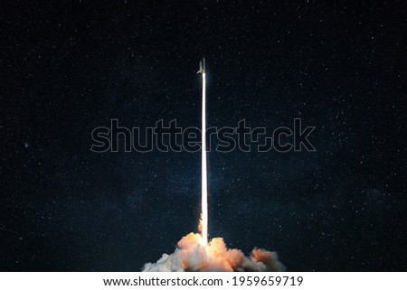 Space rocket launch into the starry sky. Space shuttle with blast and blast lift off into space on a dark background. Successful start, concept Royalty-Free Stock Photo #1959659719