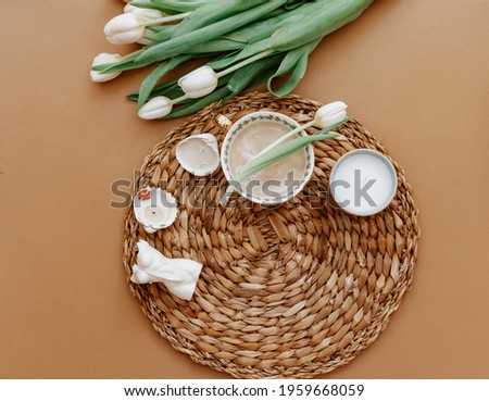 Flat Lay Morning coffee for mother day, 8 march. Coffee Cup, croissant on brown background. Fresh white tulips. Spring concept, still life composition