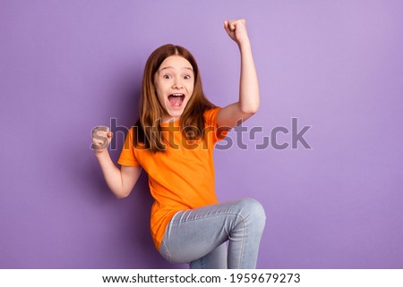 Portrait of attractive cheerful lucky girl dancing rejoicing having fun isolated over violet purple color background