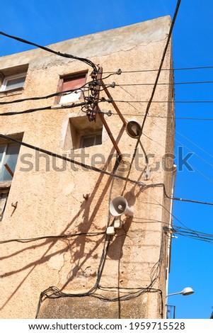 Typical electricity and electricity wires on old house in Spain