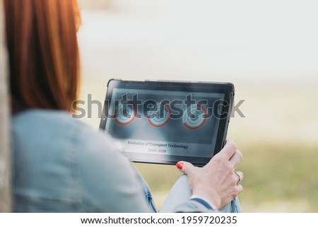 Red-haired woman looking at the tablet