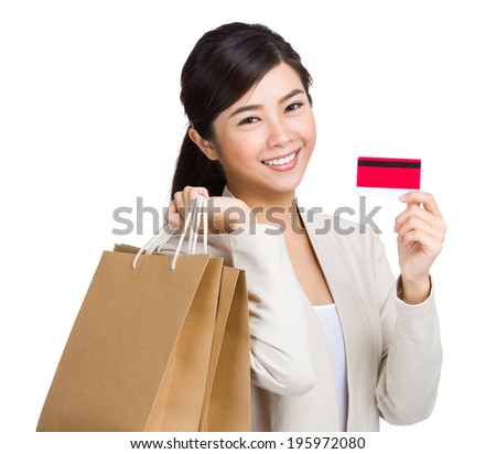 Happy woman using credit card for shopping
