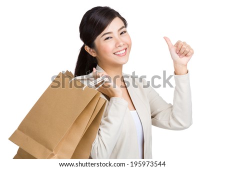 Asian woman thumb up and holding with paper bag