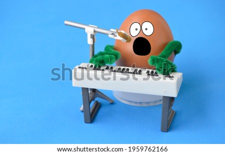 An egg singing and playing the piano.