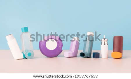 Set of asthma inhalers for asthma and COPD patients on table. Pharmaceutical product is used to treat lung inflammation and prevent asthma attack symptoms. Health care and medical concept. Copy space. Royalty-Free Stock Photo #1959767659