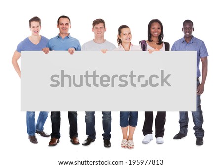 Full length portrait of diverse people in casuals holding blank placard over white background