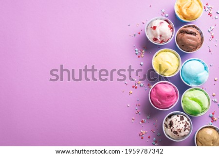 Ice Cream Assortment. Various ice creams or gelato on purple background, copy space. Frozen yogurt  in paper cups - healthy summer dessert.