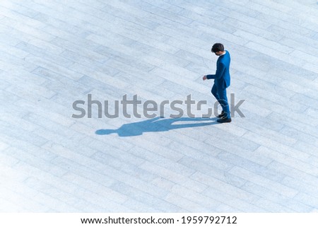 top aerial view businessman people walk on across pedestrian concrete with black silhouette shadow on ground, concept of social still life.