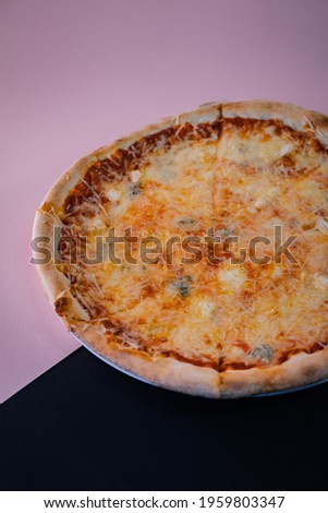 An appetizing homemade hot pizza over black and pink background