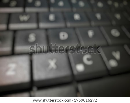 Defocused abstract background of black laptop keyboard.