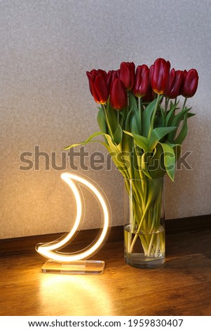 Neon moon sign with beautiful red tulips. Trendy style. Floral background. Neon sign. Custom neon. Home decor.