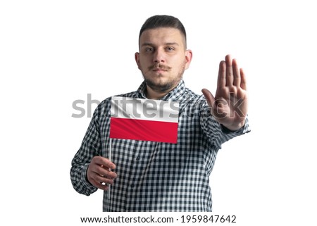 White guy holding a flag of Poland and with a serious face shows a hand stop sign isolated on a white background.
