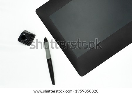 Professional graphic tablet with digitized pen. Isolated on a white background. High-resolution photo.
