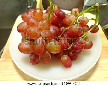 Small red grapes without seeds, sweet and delicious.Selective focus.