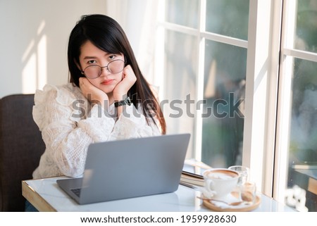 Happy of beautiful asian freelance people business female casual working with laptop computer with coffee cup and smartphone in coffee shop like the background,communication concept