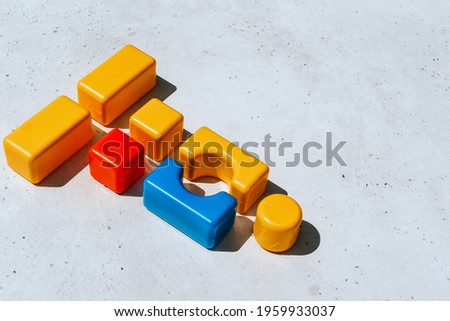 Children's blocks on a white concrete background