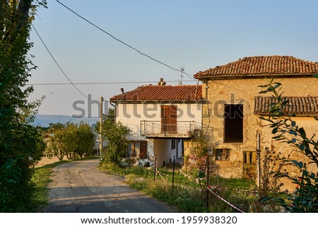Abandoned house in ruins, concept of empty small towns, sign saying "for sale" in a small village of Emilia Romagna, Italy.                               