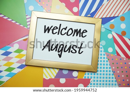 Welcome August text on colorful background