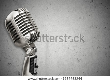 The professional microphone on wall background, urban audio recording