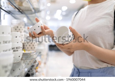 Asian woman shopping for items in store