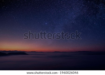 The stars and the milky way in the dark night sky are very beautiful. Royalty-Free Stock Photo #1960026046