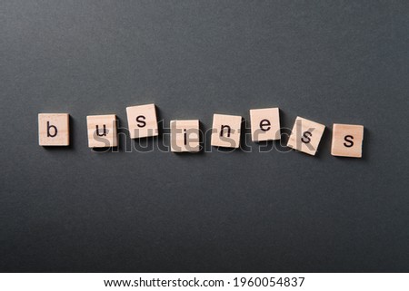 The word "business" made from wooden cubes on a dark background