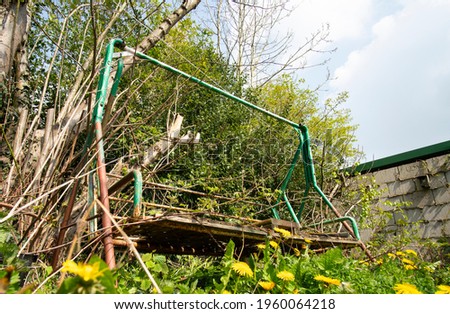 Rusty old garden swing example