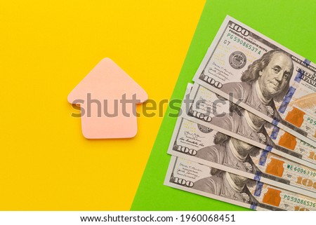 House figure with cash dollar banknotes, as symbol of investment in property to get profit. Insurance of property to protect.